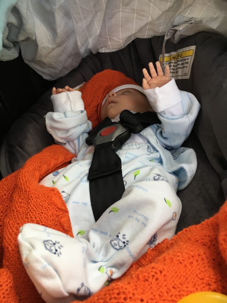 new nicu grad premature baby boy going home in a cosco dreamride car bed safely
