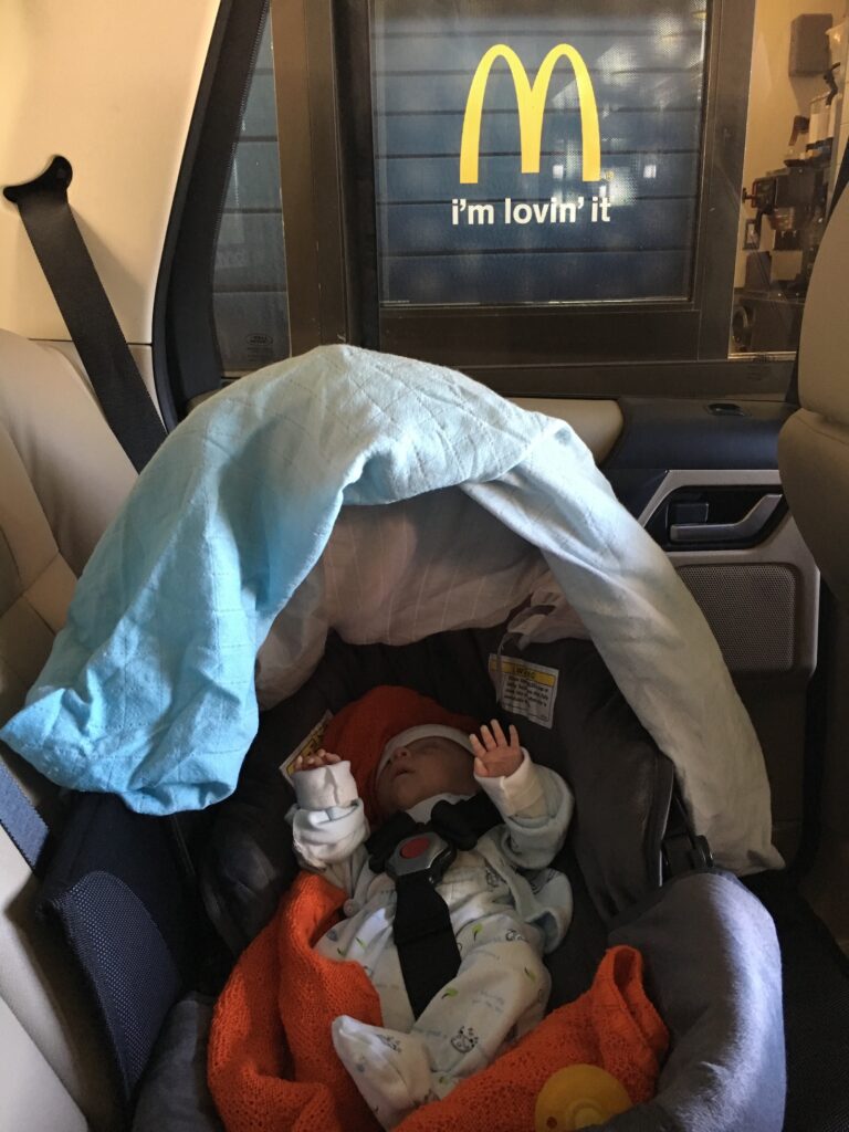 4 week old preemie infant is too small to ride in a car seat rides in a car bed instead and going through the McDonalds drive through