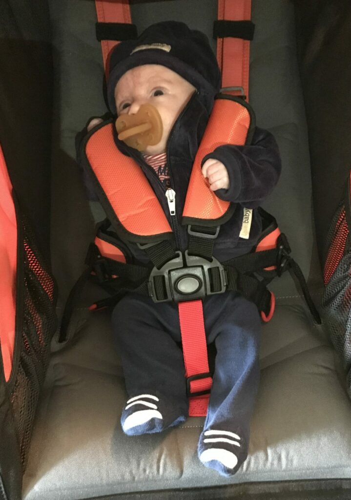 Premature Baby Boy in a BOB Stroller with Natural Rubber Pacifier from Natursutten