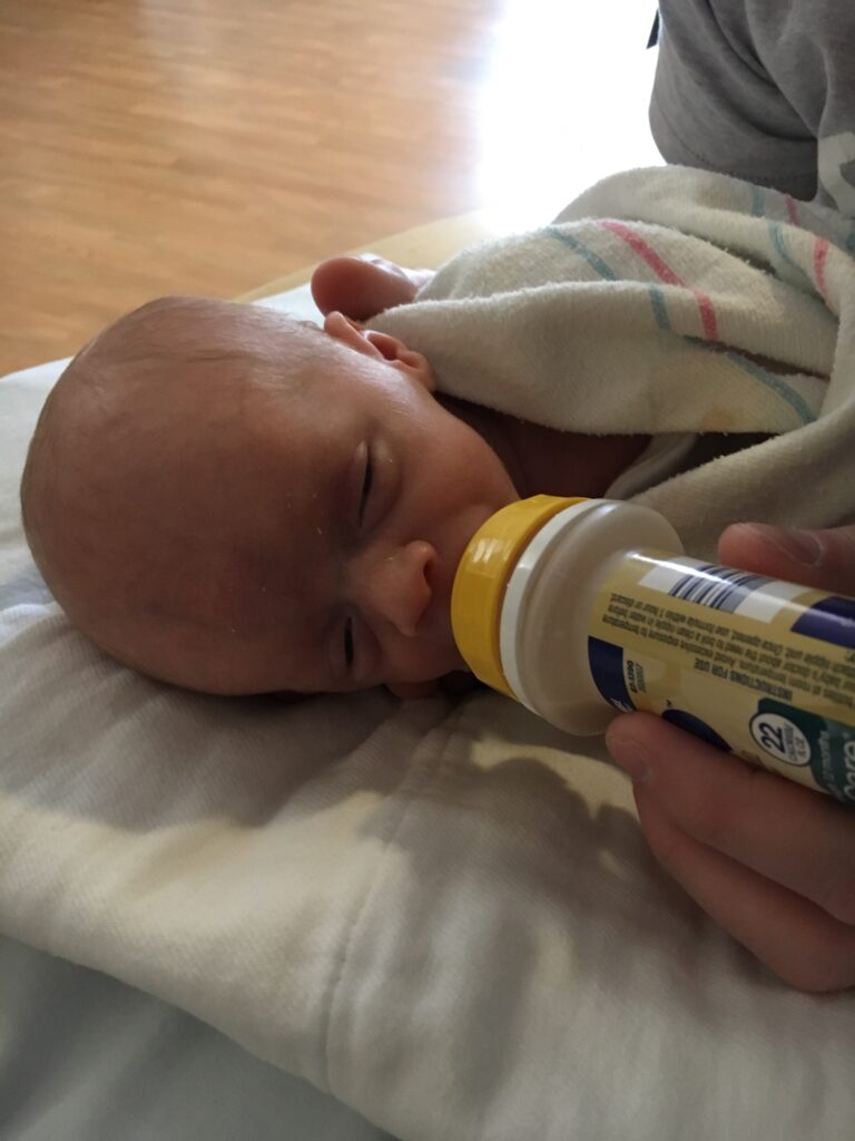 Formula fed newborn premature baby with high calorie liquid ready to drink formula from enfamil