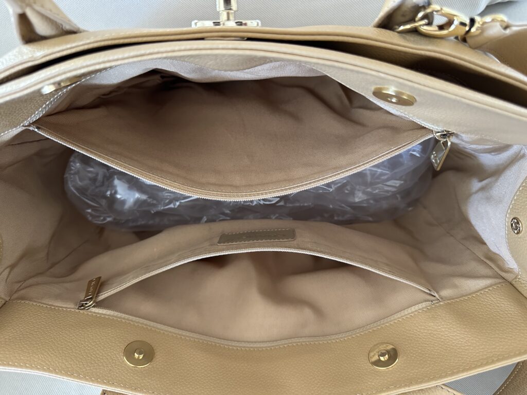 Interior photo of a Vintage Chanel Executive Cerf Tote which includes 2 zipper closure pockets which are large and roomy