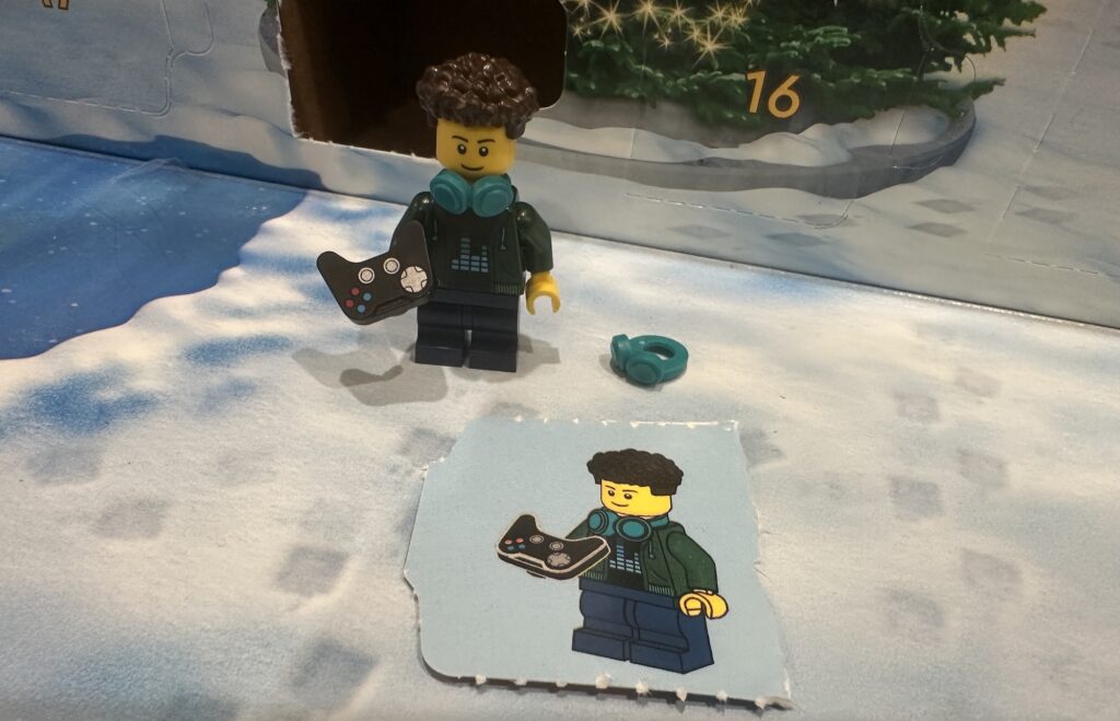 Day 11 LEGO City Advent Calendar is a Video Gamer Minifig Minifigure Person Figure with PS controller, turquoise Beats headphones, cool hair and a cool outfit.