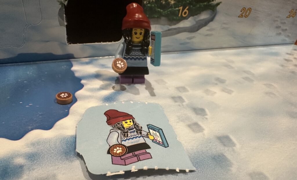 Day 14 LEGO City Advent Calendar Young Kid Minifig Tween Teenage Girl with a Smartphone Iphone and cookie dog treat plus a bonus treat and instructions on how to build