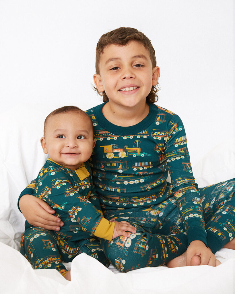 Piccolina Kids Locomotive Print Line features onesies for babies, pajamas for toddlers and kids and other clothing with the cute train print.