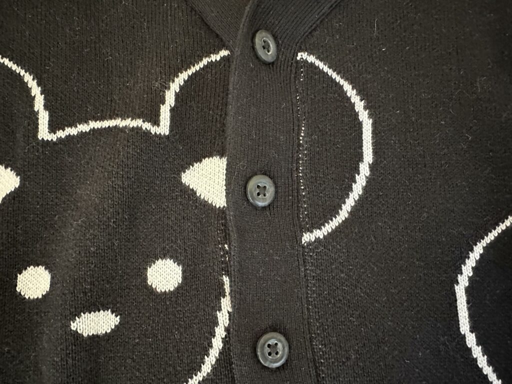 Huxbaby Close up on the Black Plastic Buttons on the Mickey Mouse Inspired Cardigan Sweater