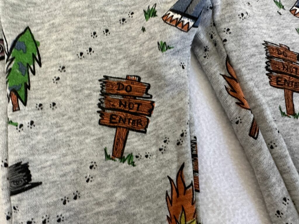 Stella McCartney Kids Summer Camp Outdoor Camping Print on Light Grey Background Features Wooden Signs, Teepees, Bandaids, Animal Footprints Pine Trees, Explorer Signs and Much More