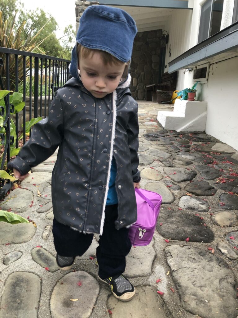 Two Year Old Boy Wearing ZARA Baby size 2/3 Lined Rain Jacket while going to daycare.