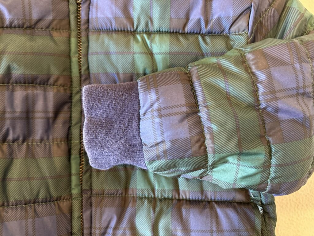 GAP Puffer coat shows wear and tear on the cotton blend banding
