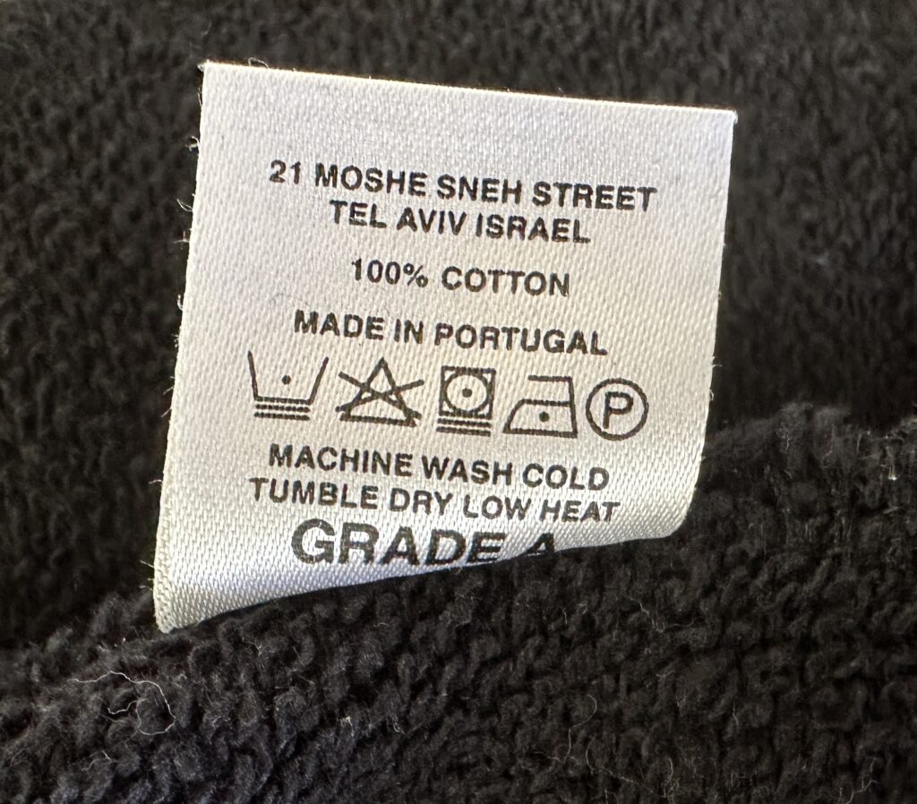 Nununu Made in, Fabric Content and Care instructions on interior tag of garment