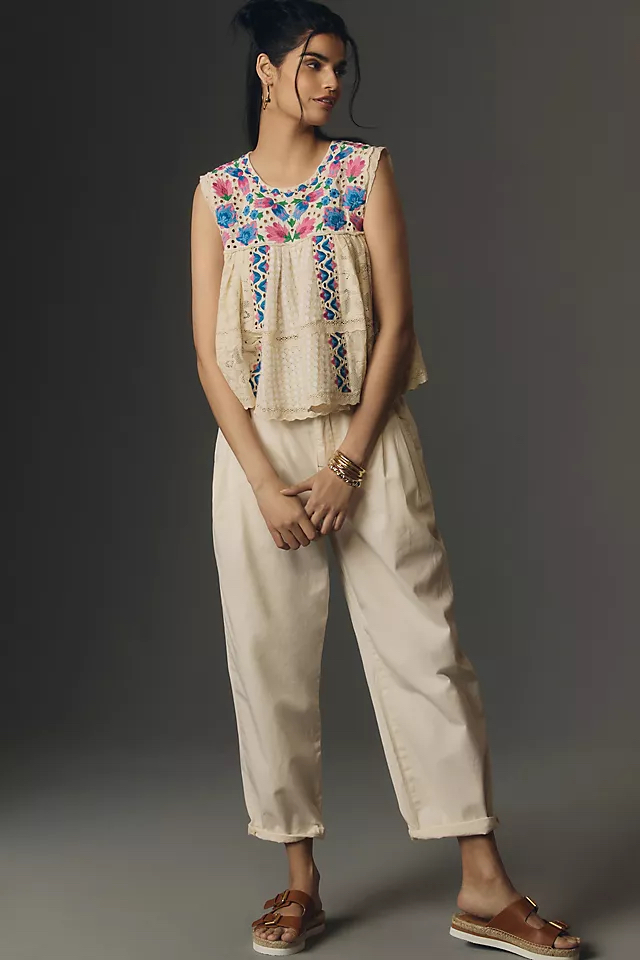 Modeling Shot of the Anthropologie Let Me Be Sleeveless Embroidered Babydoll Blouse