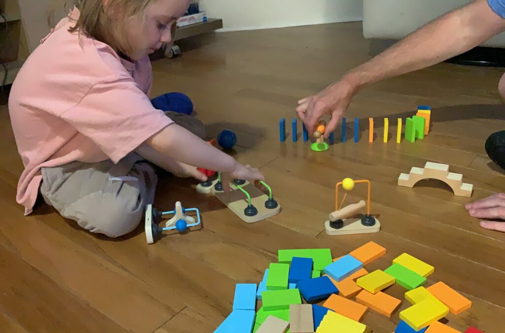 Practice quiet time and patience with your young child toddler by stacking dominoes