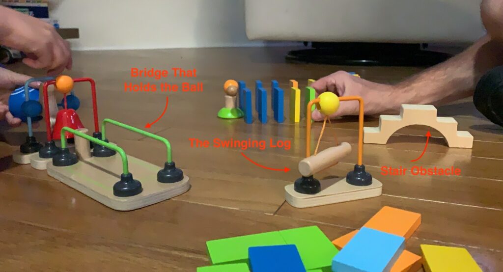 HAPE Toppling Domino Obstacles and Extras Such as a Bridge that Holds the Ball Before Rolling, A Swinging Log and a Staircase Obstacle