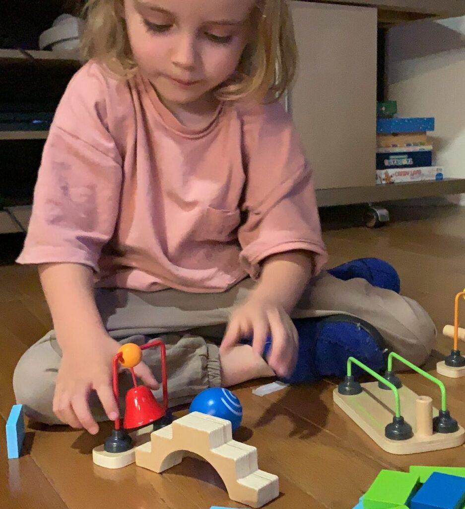 Introduce Toddlers to Toppling Dominoes with HAPE includes so many kid appropriate STEM and STEAM inspired obstacles