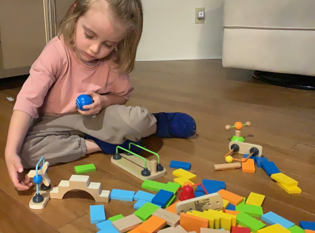 Toddler's first reaction to Toppling Dominoes how to introduce toddlers and young children to wooden domino obstacles racing and toppling